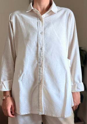 White shirt and beige pants worn by a person against a neutral background